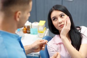 woman in dental chair with sore tooth